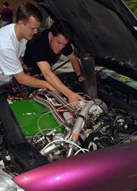 students working on car project